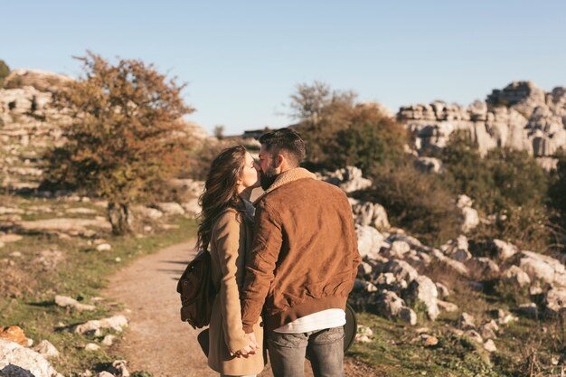202601beautiful-couple-kissing-nature_23-2148377871