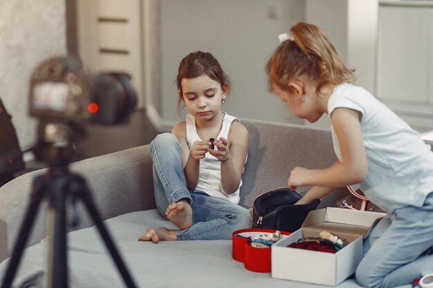 202601cute-little-blogger-with-cosmetics-recording-video-home_1157-37302
